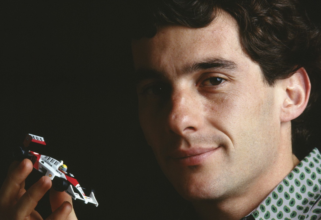 Ayrton_Senna_with_toy_car_cropped_no_wm